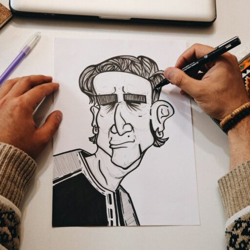 person holding pen drawing on white paper